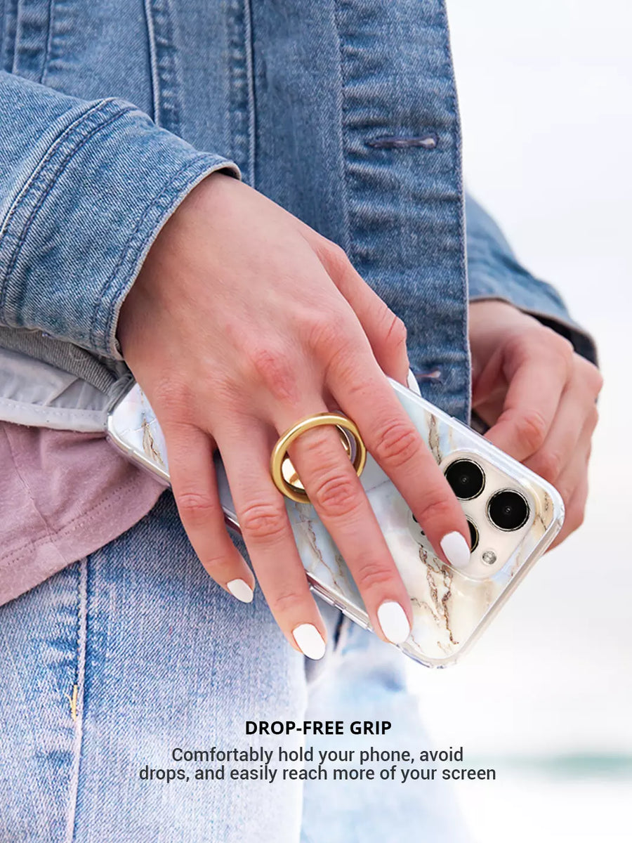 Wearing gold phone ring with an iphone case on white nails on hand