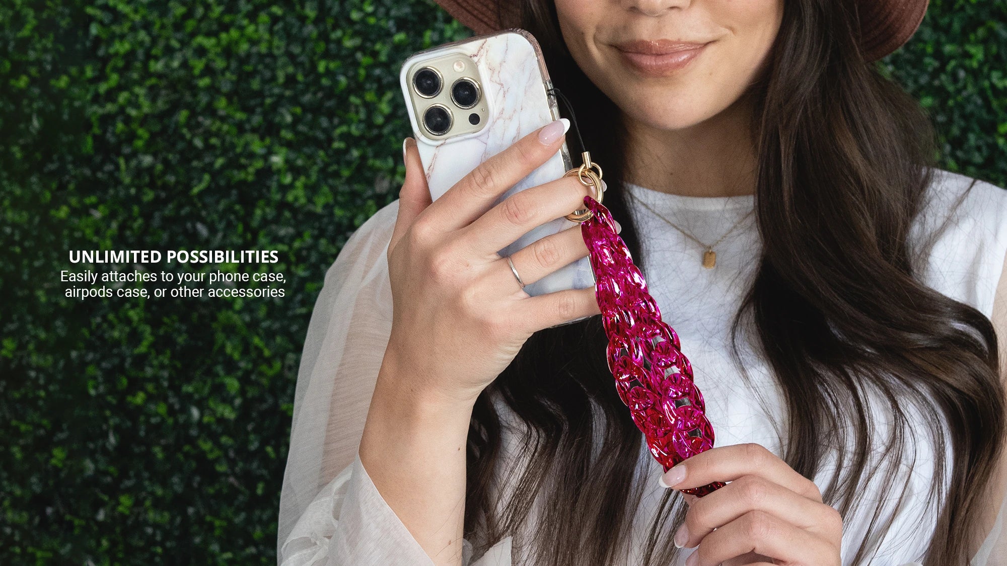 Holding iphone with Hot Pink Holographic Phone Wristlet Charm