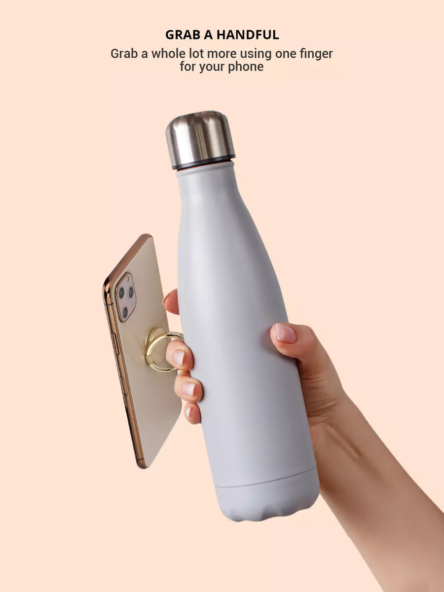 Grasp the iPhone with one finger through the gold phone ring while holding a tumbler