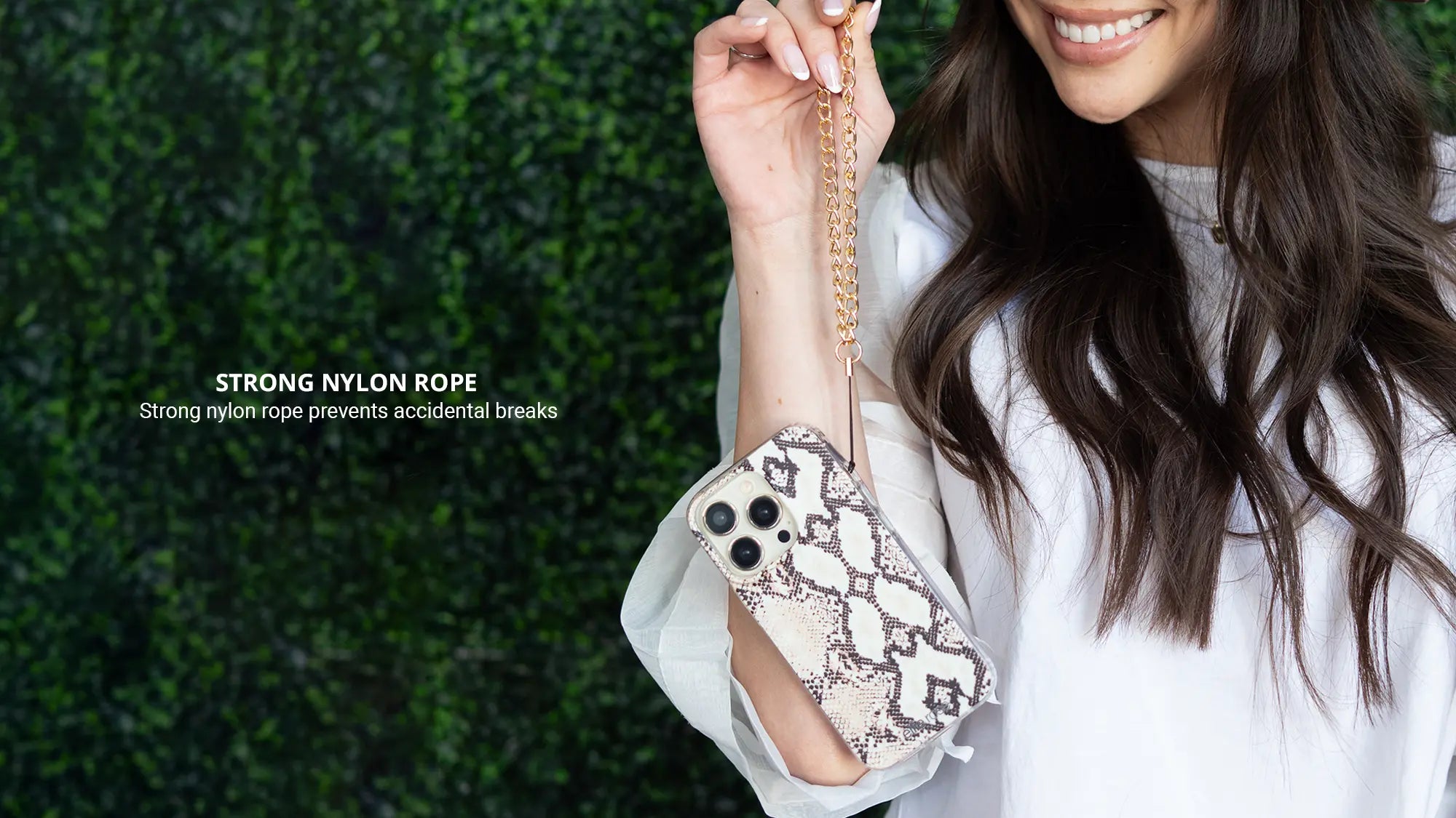 Gold Phone Wristlet Charm while wearing white tops