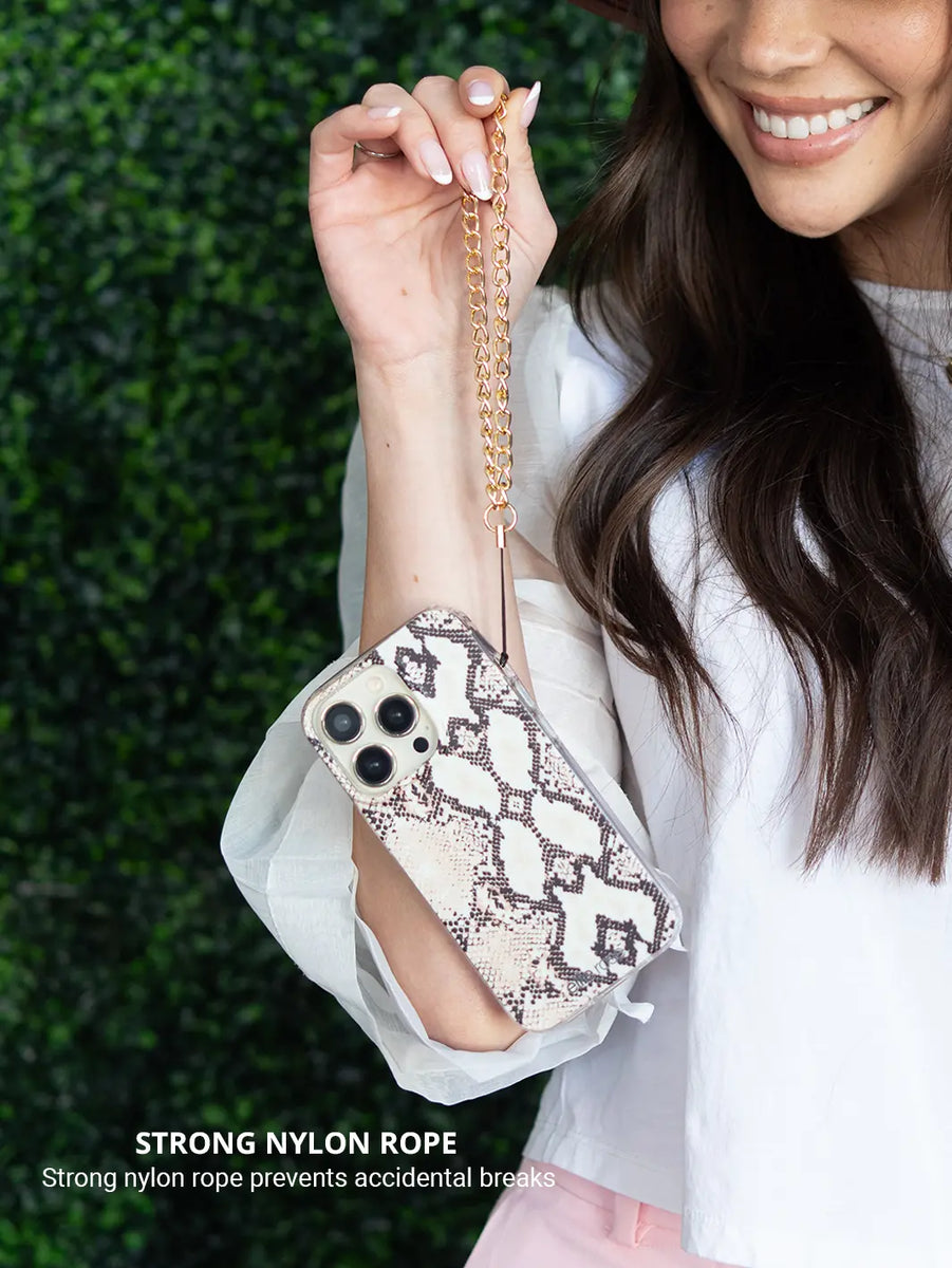 Gold Phone Wristlet Charm  while wearing white tops