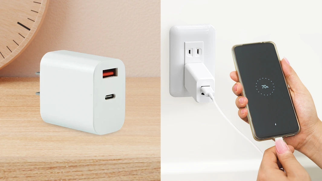 White Desktop wall adapter while charging an iPhone