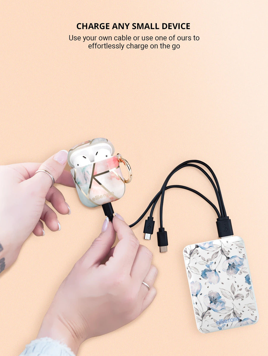 blue floral power bank with 3 in 1 usb  charging cable connected to peachy green airpods case