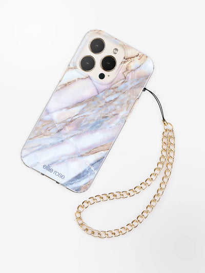 Gold phone wristlet charm latched to iPhone with desert marble case