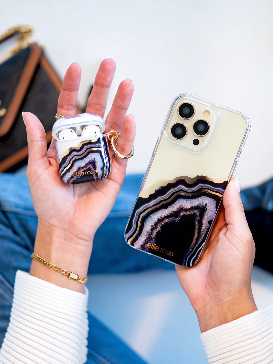 Black Agate AirPods Case held in hand with iphone