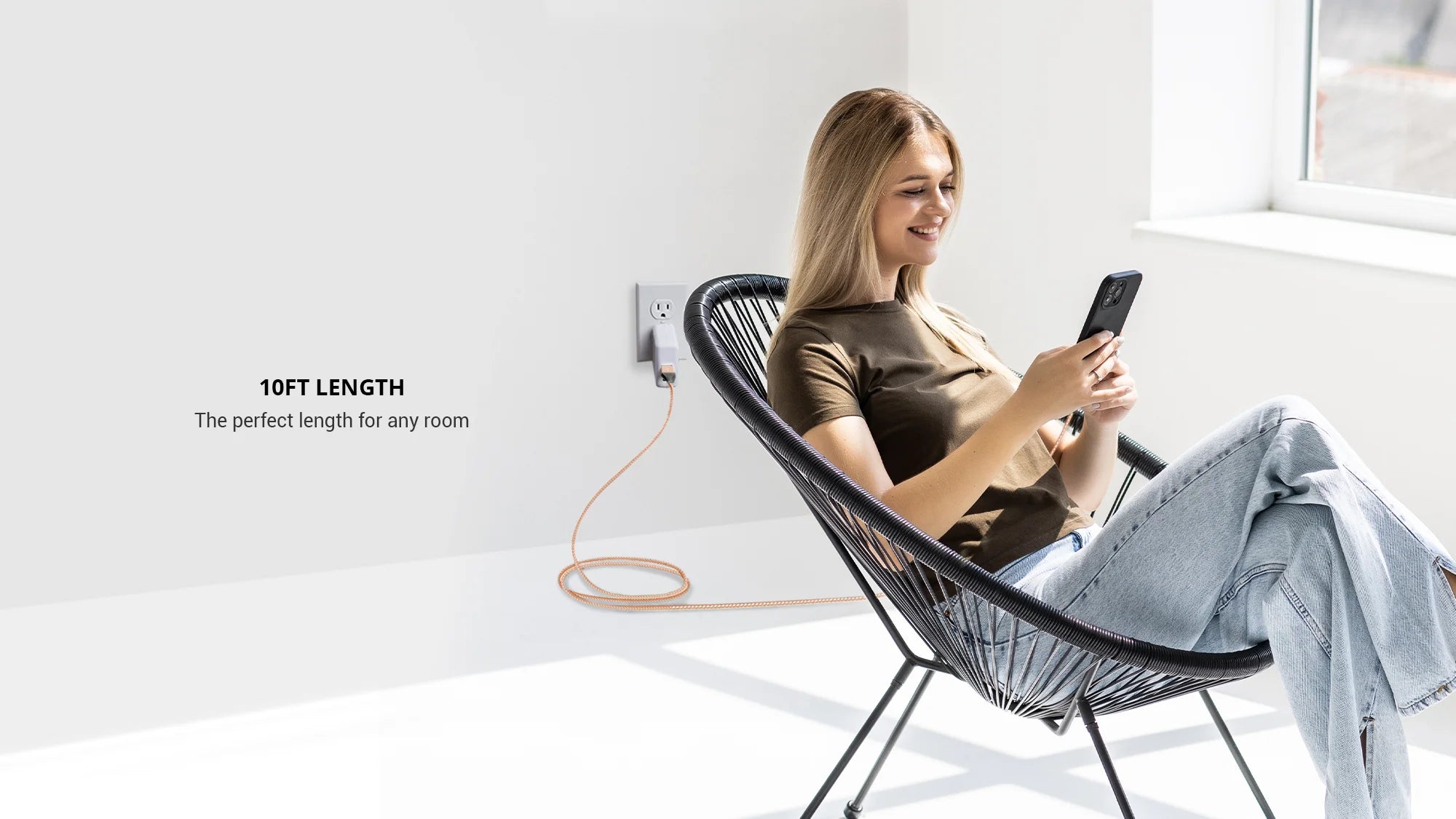 Charging an iphone using Rose gold 3 in 1 charger USB A sitting on black chair