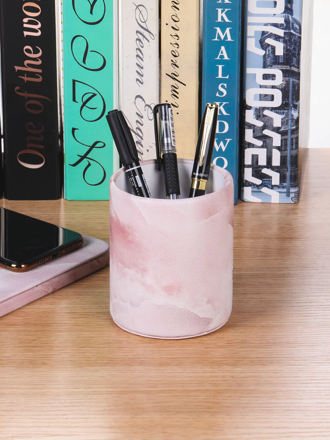 Pink Onyx pen cup with ballpens and books