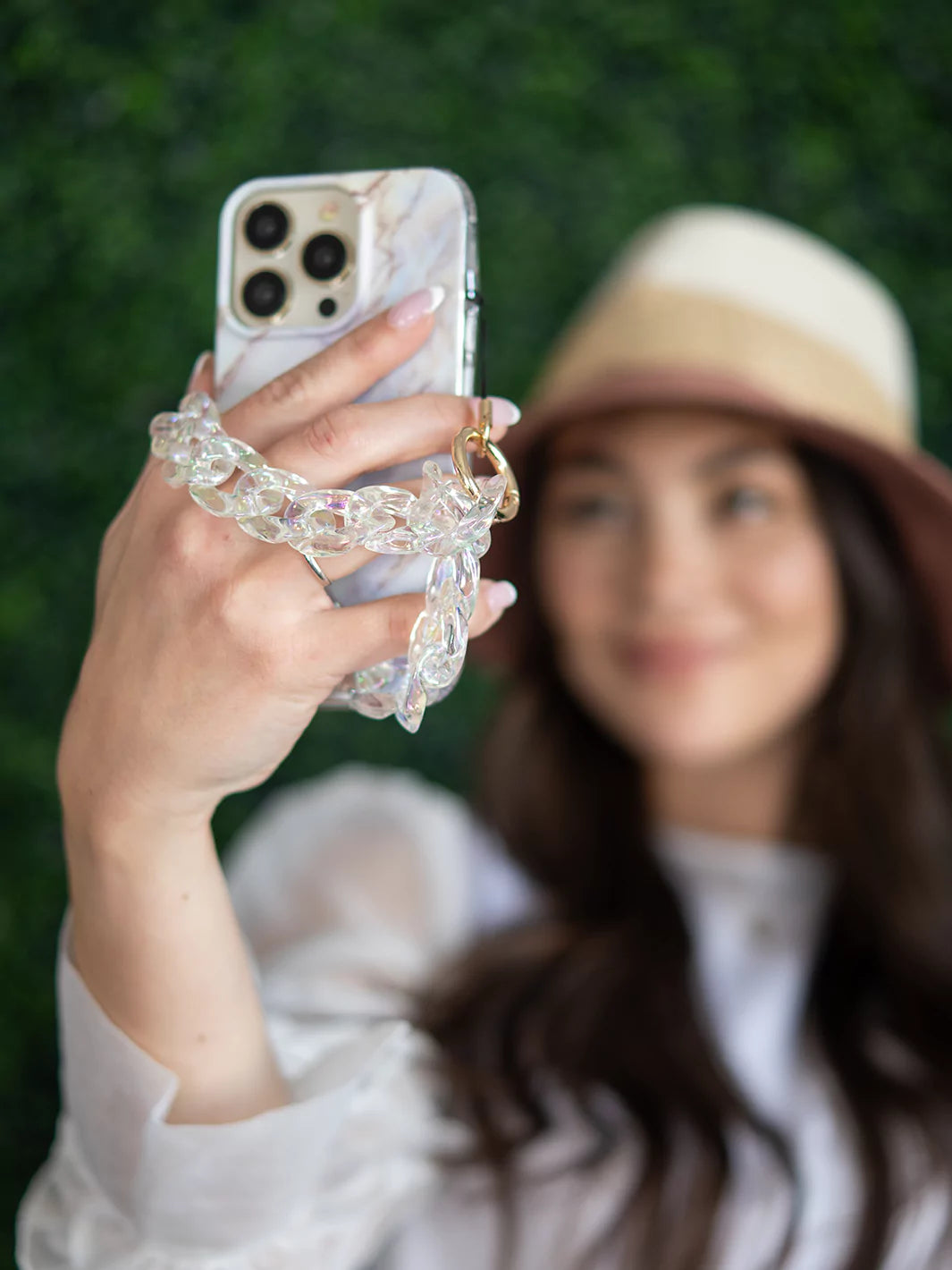 Taking selfie from an iPhone with clear holographic phone wristlet   charm