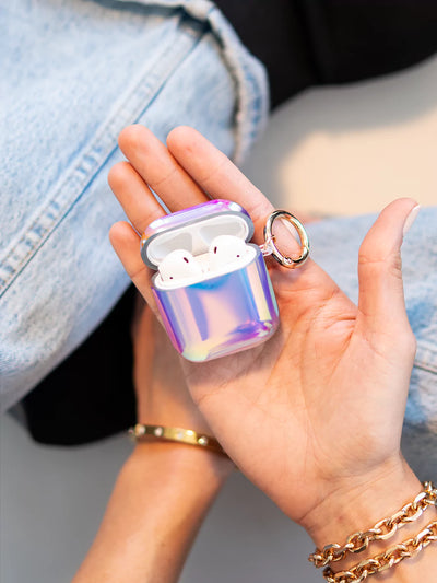 Holding aura airpods case with gold ring and blue jeans