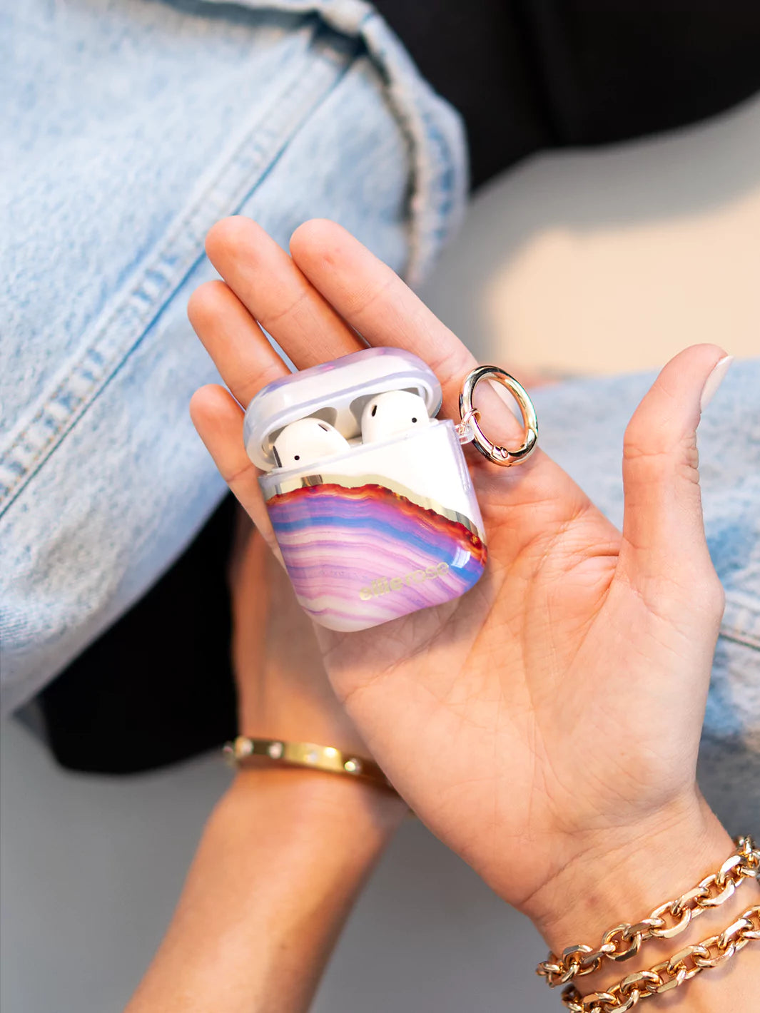 Candy Agate airpods case opening with gold ring on hand