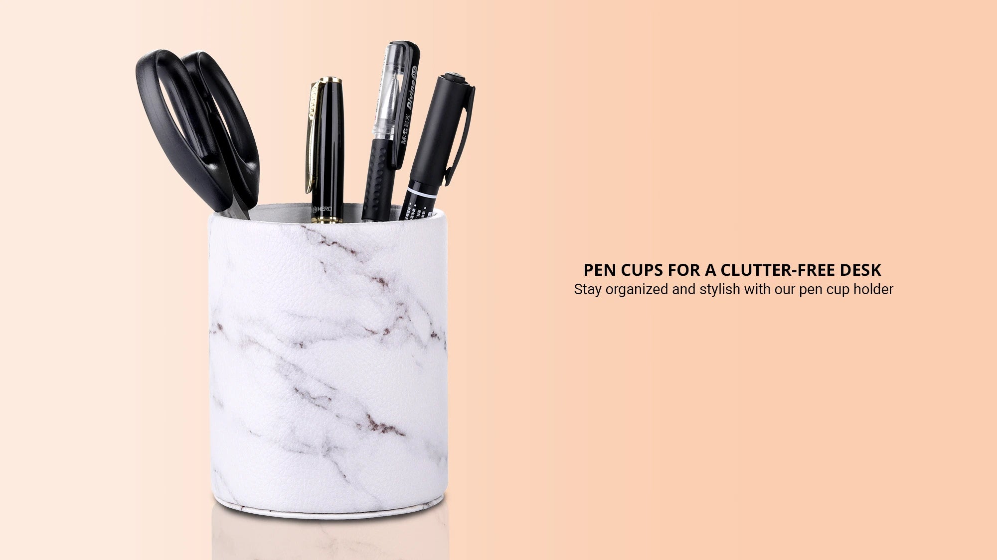 White marble pen cup with scissors and ball pens