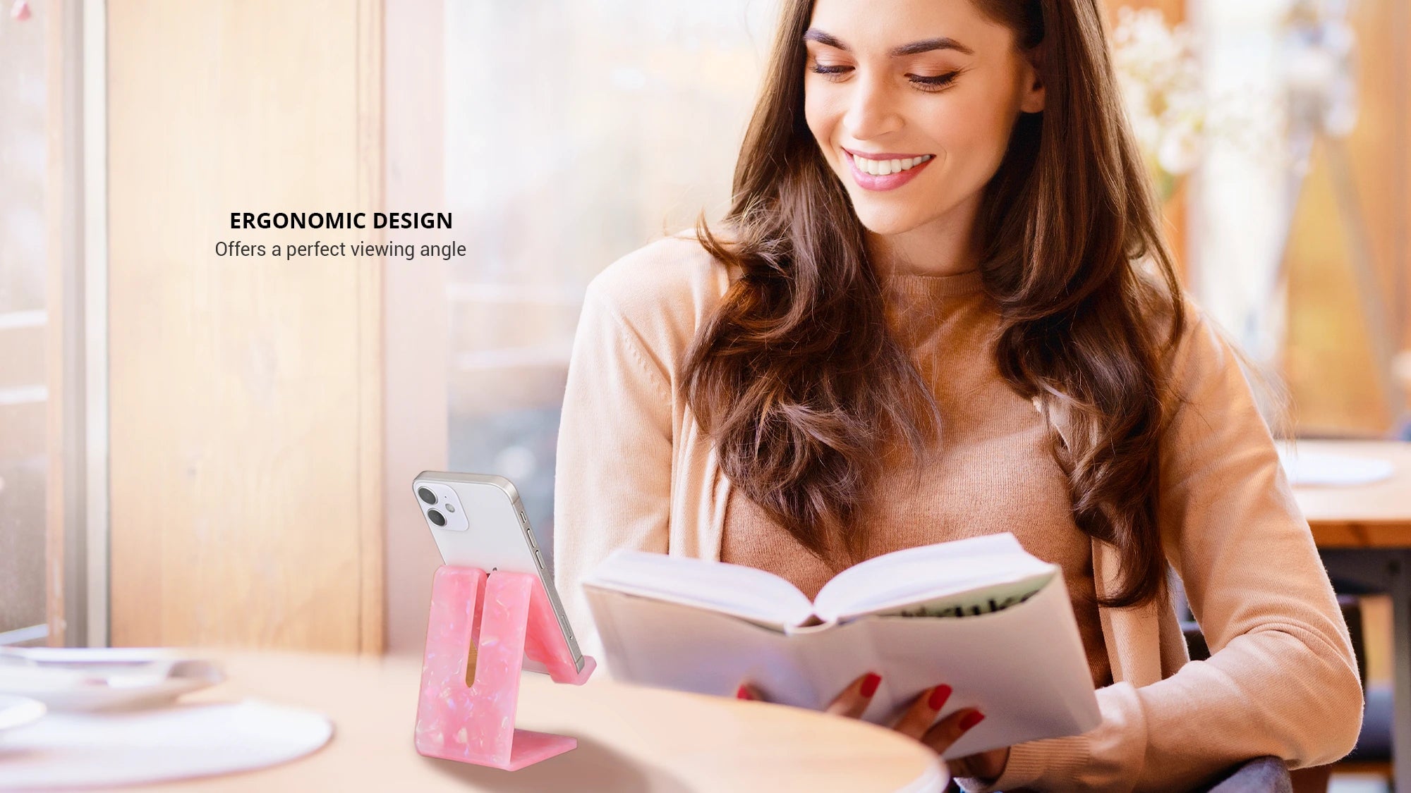 displaying rose quartz phone and tablet stand holding an iPhone