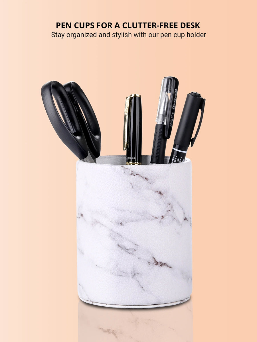 White marble pen cup with scissors and ball pens