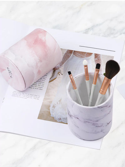 White marble pen cups with makeup brush a white wedding paper