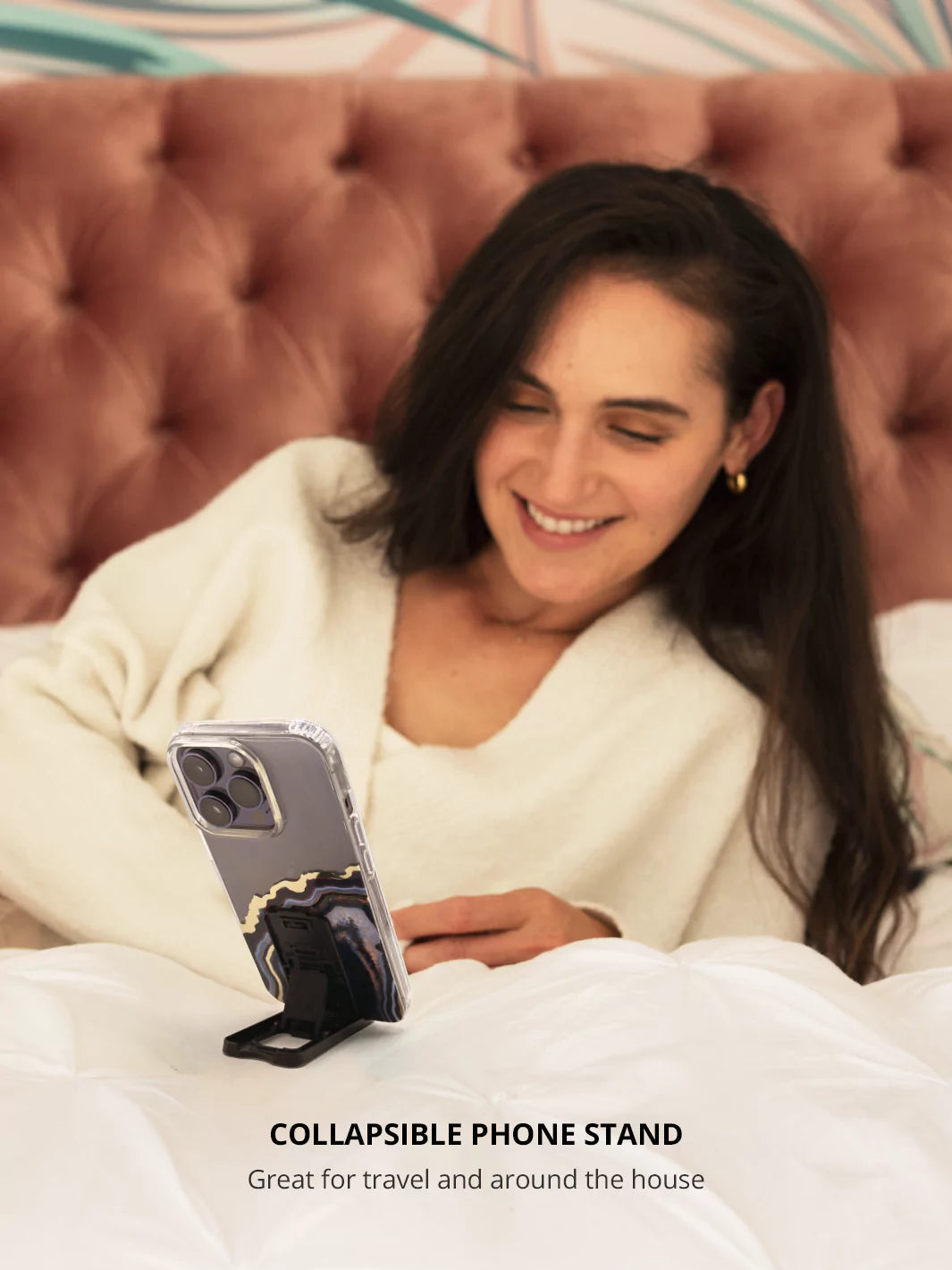 Black collapsible phone stand with an iPhone while on bed