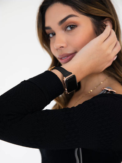 showing black leather band for apple watch while wearing black top long sleeves