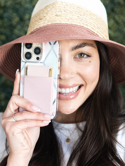 Stick on phone pocket blush one handed wearing hat