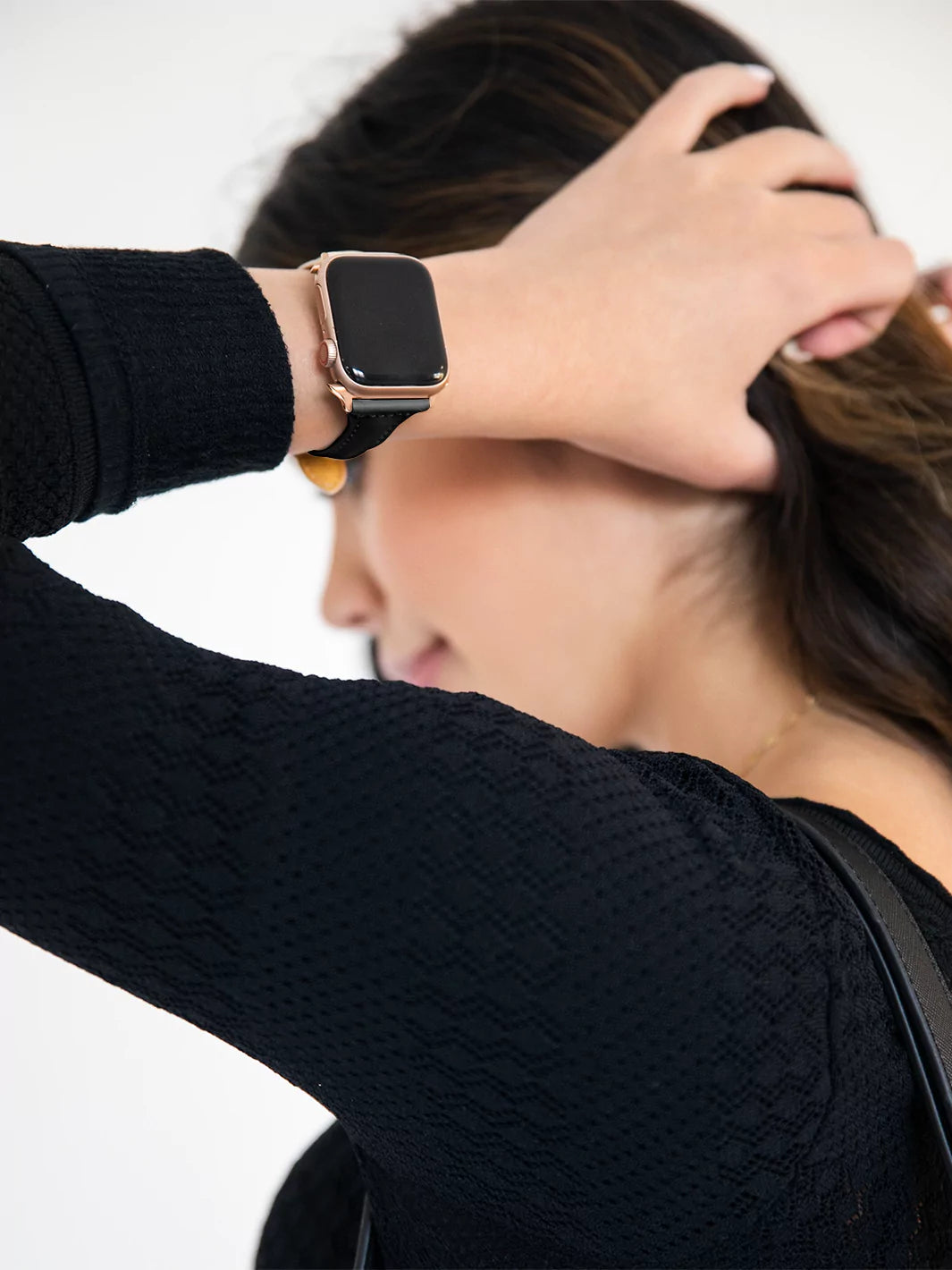 featuring black leather Apple Watch band while led screen is off styled with black long sleeves