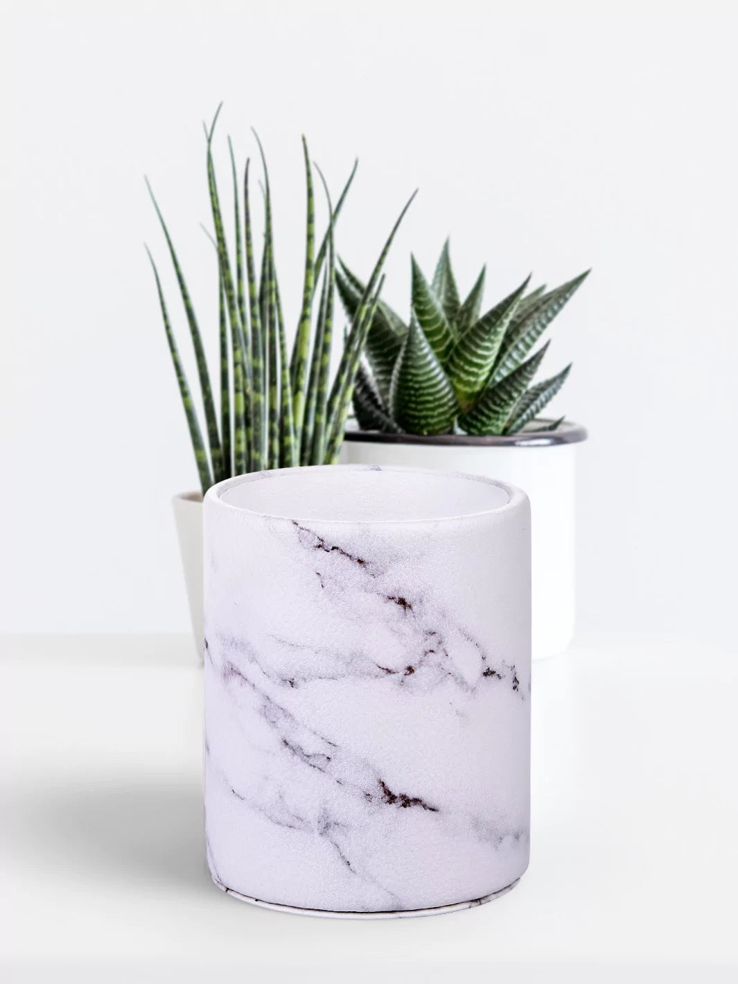 White marble pen cup with green mini plants at the back