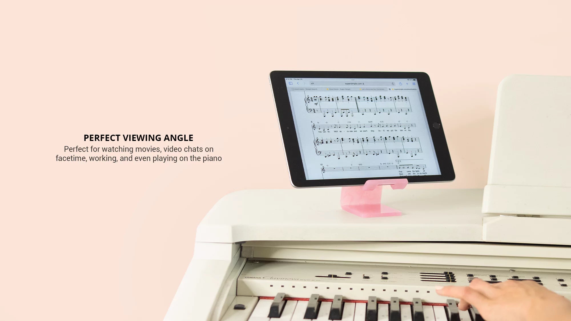 Showing the rose quartz phone and tablet stand with an iPad displayed on a piano