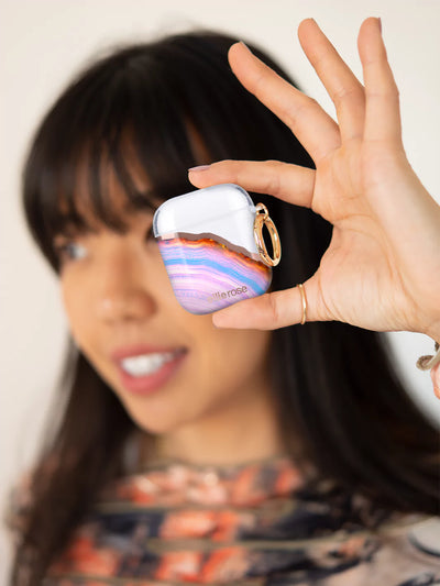 Showing Candy Agate Airpods Case on  one hand