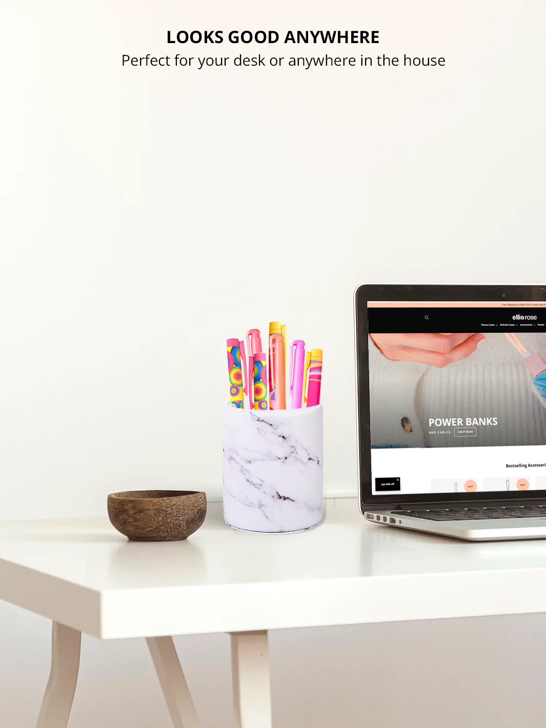 White marble pen cup with colorful pens and a laptop