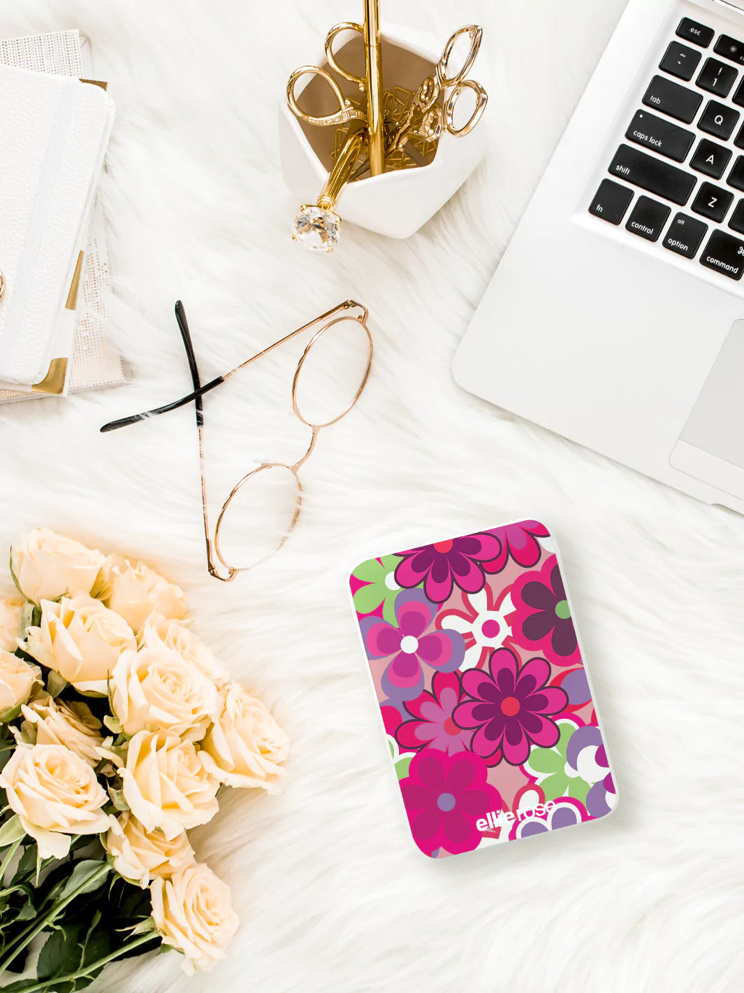 Showing Groovy Floral powerbank while charging an iPhone wearing light gray shirt and blue jeans