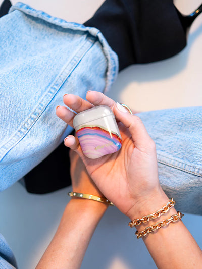 Candy Agate AirPods Case on hand with gold bracelets