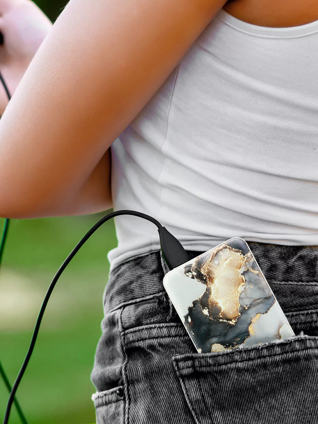 Slim Mercury marble  power bank in the back pocket of black jeans