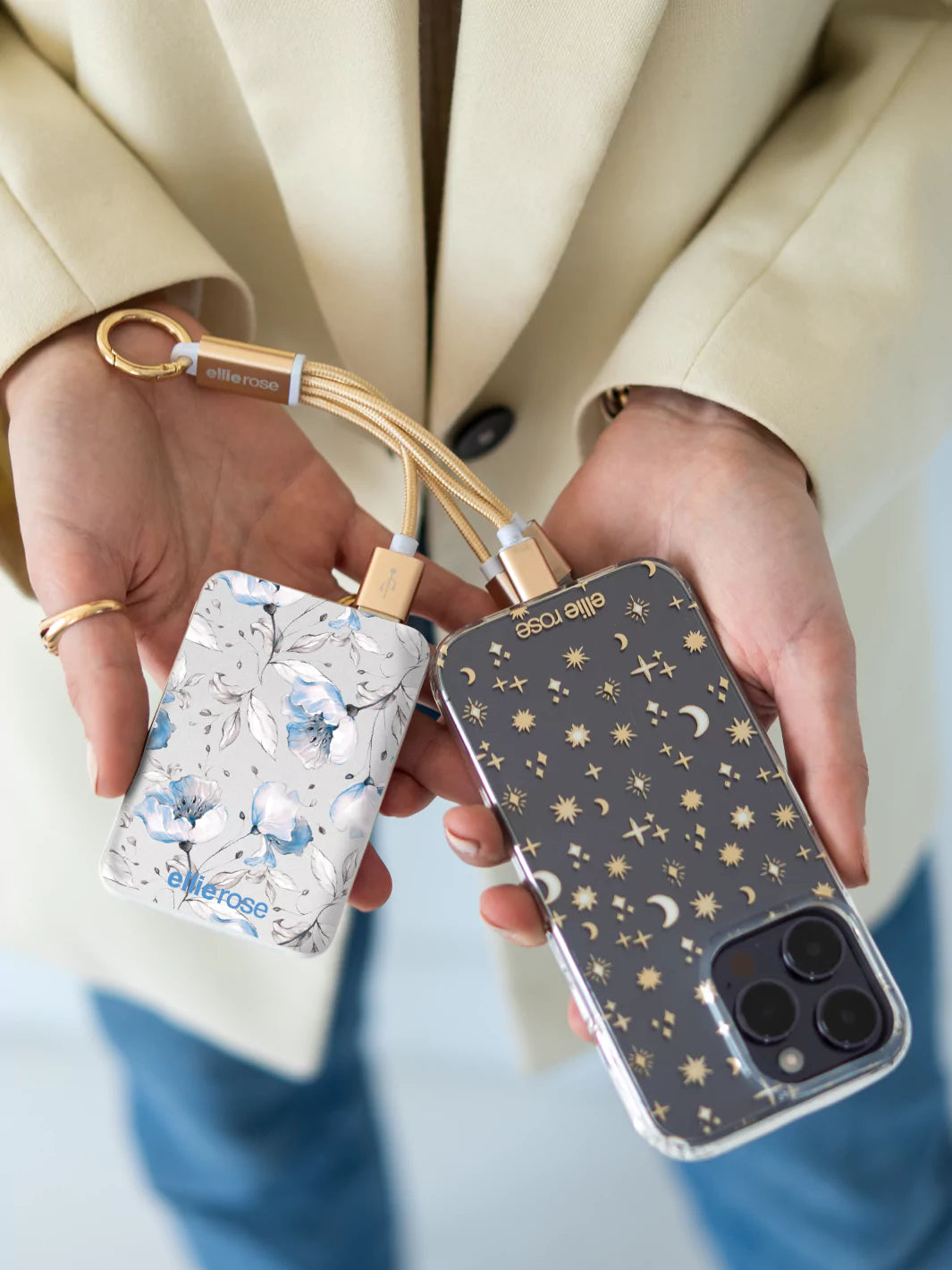 Blue floral Powerbank and 3 in 1 gold charging cable connected to iPhone 